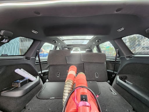 Professional fogging equipment set up inside a car during Four Solutions car fumigation in Singapore