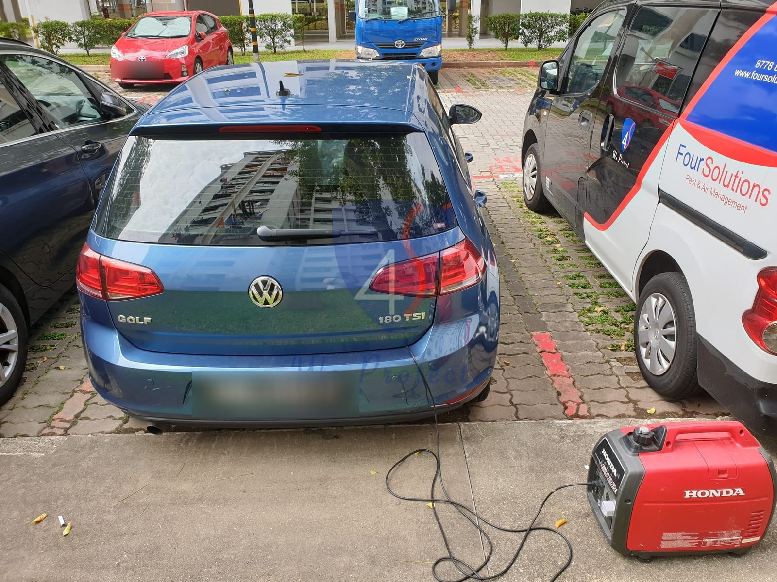 Four Solutions technician fumigating a car with a professional ULV fogging machine in Singapore