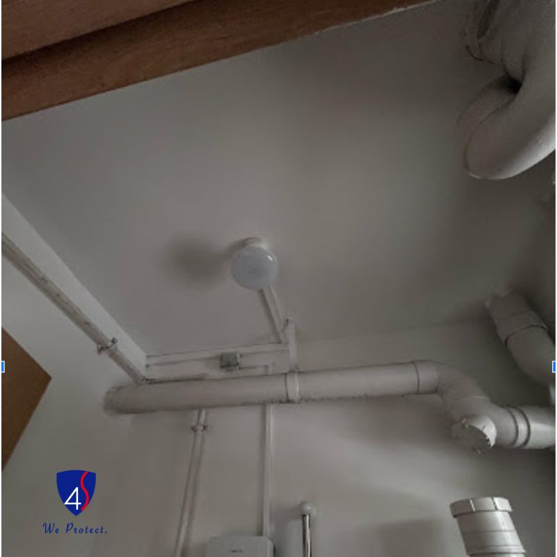 The same toilet ceiling after treatment, painted white